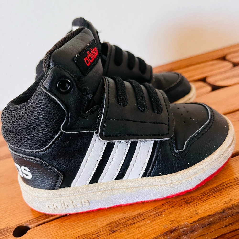 Boys Adidas basketball inspired mid-top sneaker.